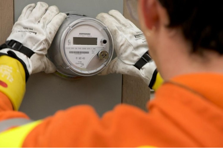 Utility worker installing a digital smart meter